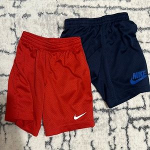 2 pairs of Nike size 6 shorts. Navy blue and red.